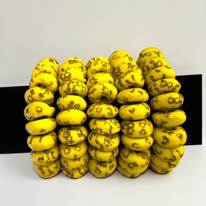 Krobo Bead Stretch Bracelet – Ghana Glass, Yellow with Painted Focal Bead - Fatisha Boutique