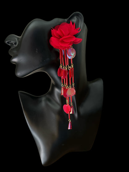 Red: Long red flower earring with iridescent sequin tassel drops displayed on a black mannequin.