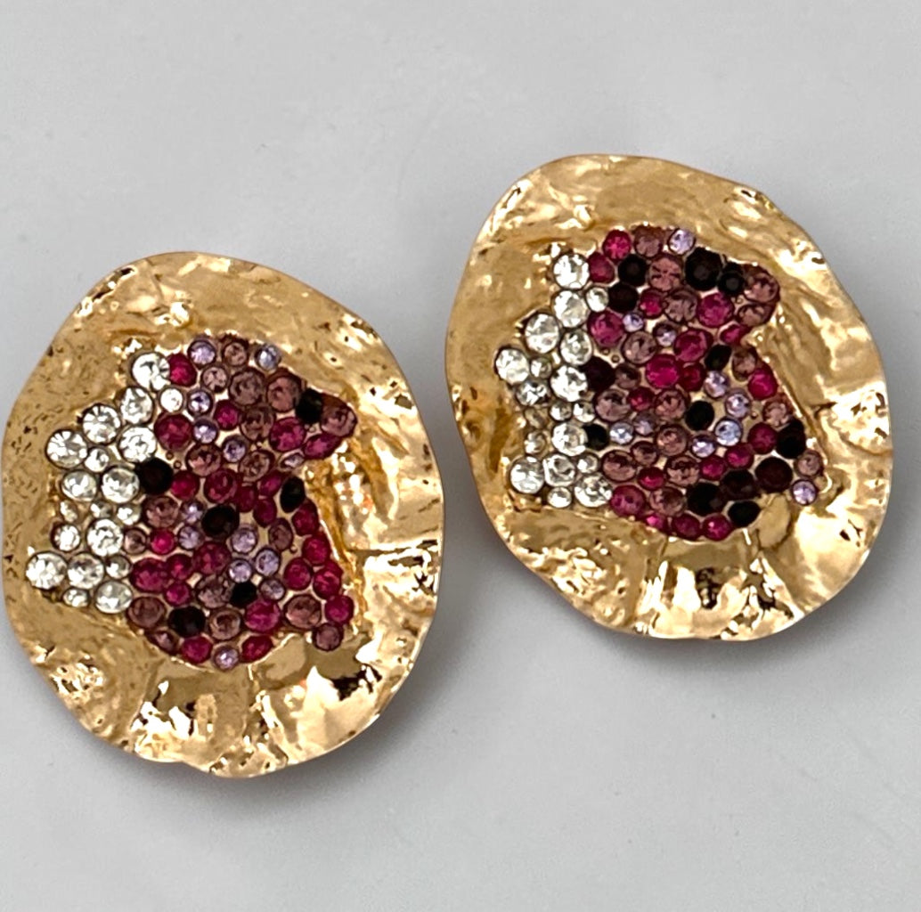 Gold hammered statement stud earrings with pink, burgundy, clear and dark rhinestone cluster detail. Fatisha Boutique