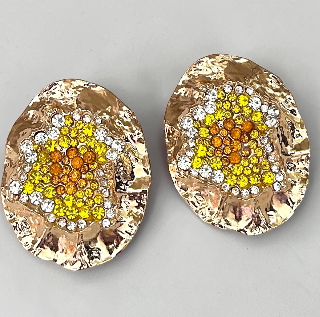 Gold hammered statement stud earrings with yellow, orange and clear rhinestone cluster detail. Fatisha Boutique